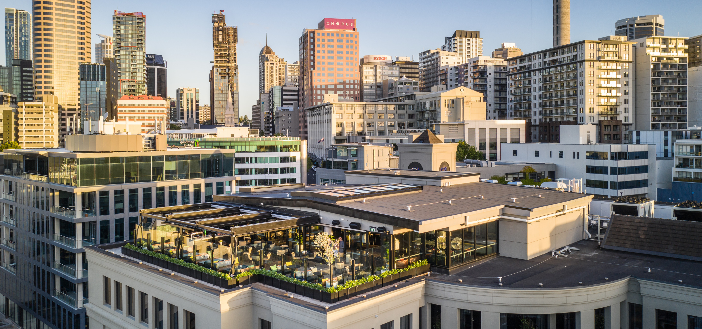 QT Auckland's elegant rooftop bar offers sophisticated indoor-outdoor dining with expansive city views.
