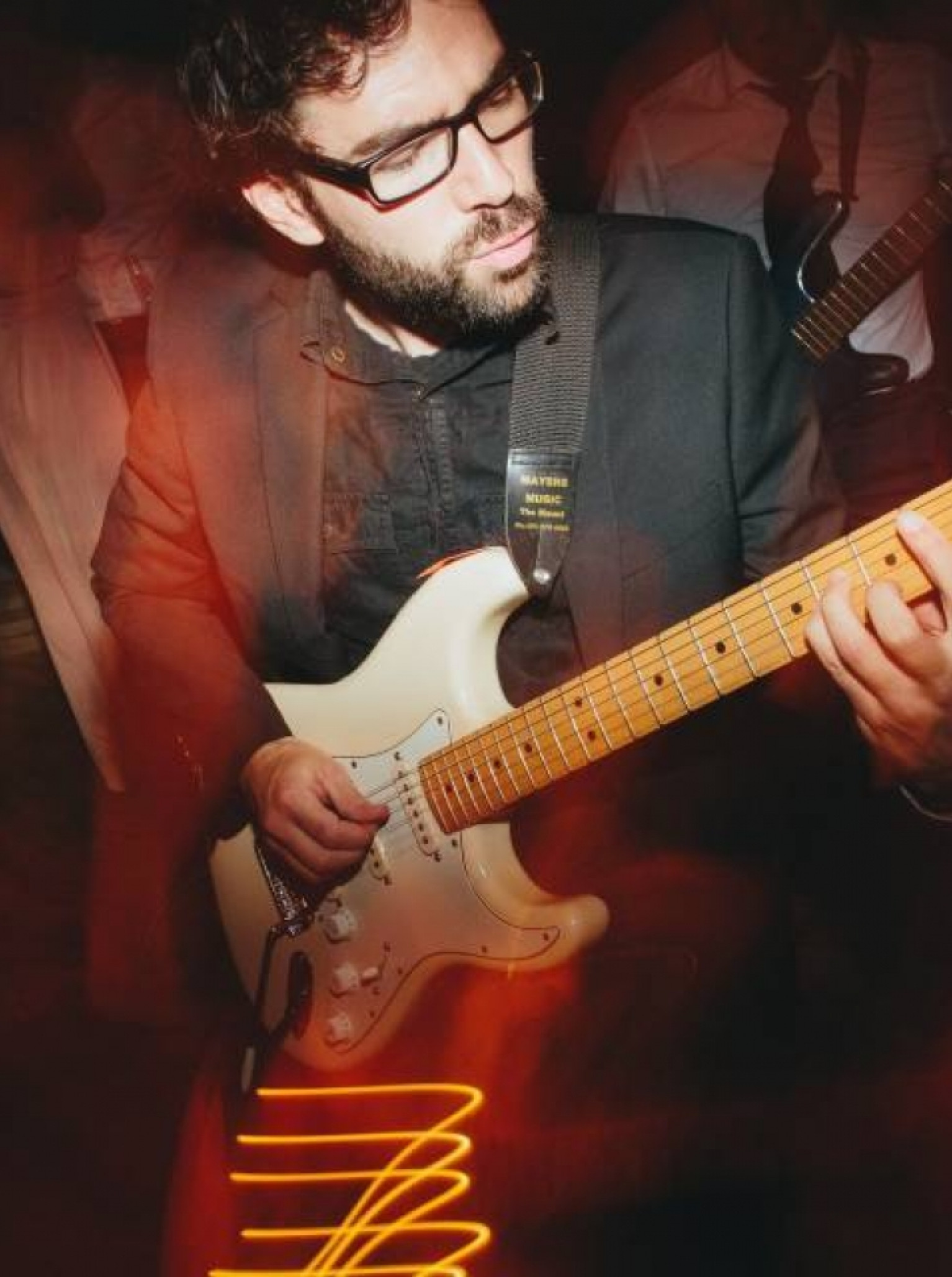 A musician from Empire Agency Auckland passionately plays an electric guitar, providing lively entertainment.
