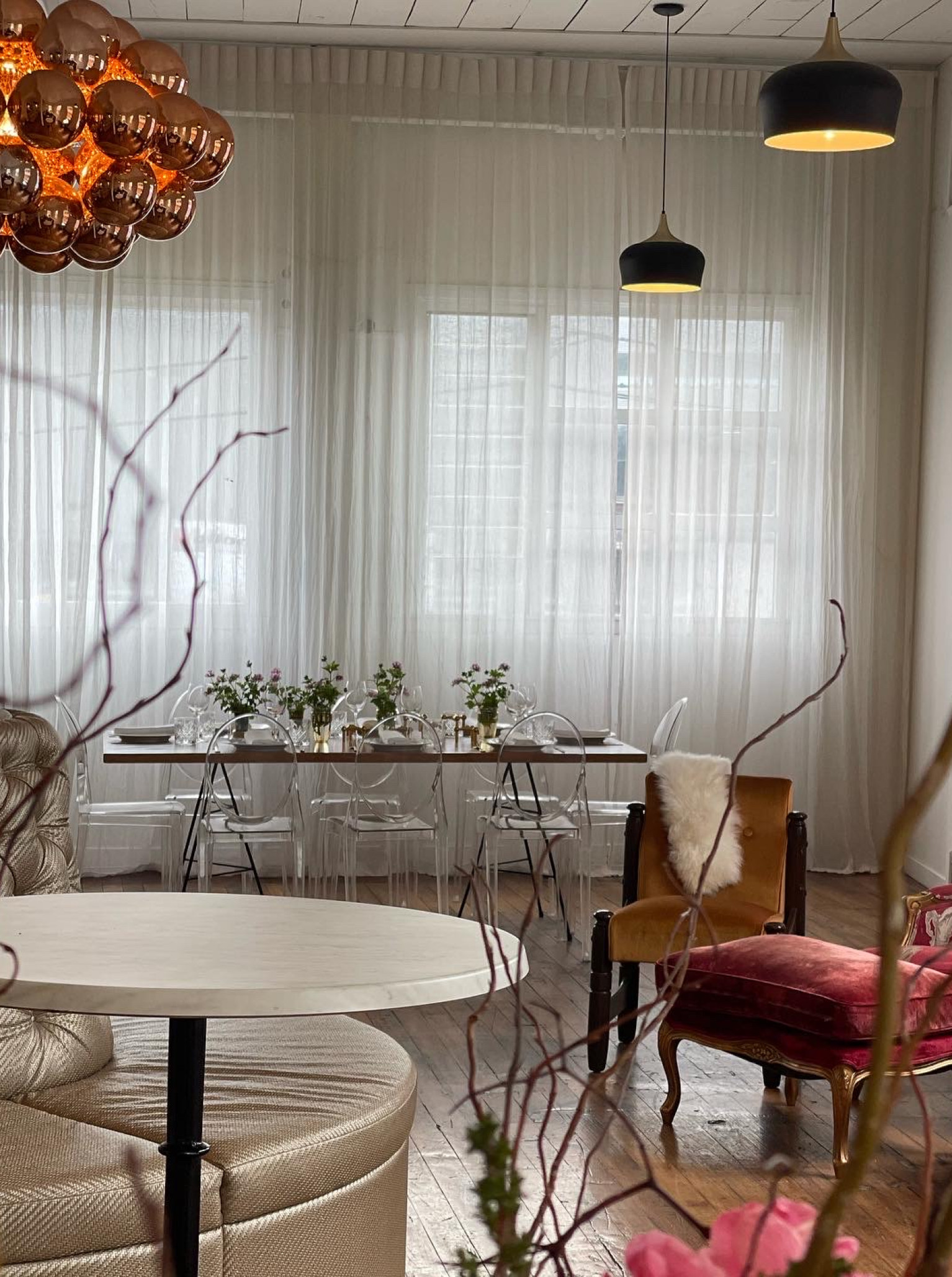 A chic private dining space at The Canapé Room, Wellington, features elegant vintage furnishings and abundant natural light.