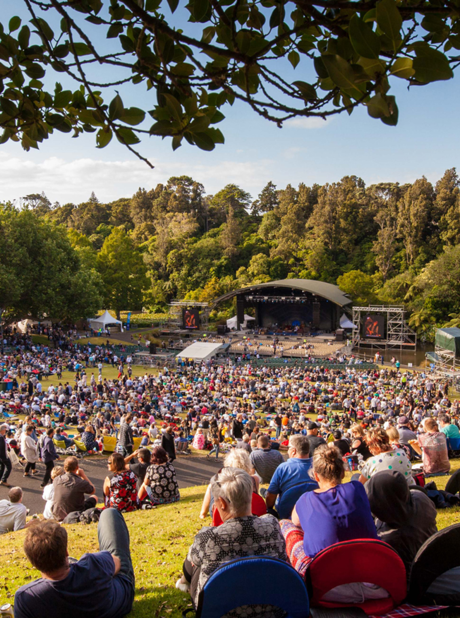 An outdoor concert event fills the natural amphitheater of the Bowl of Brooklands in New Plymouth.