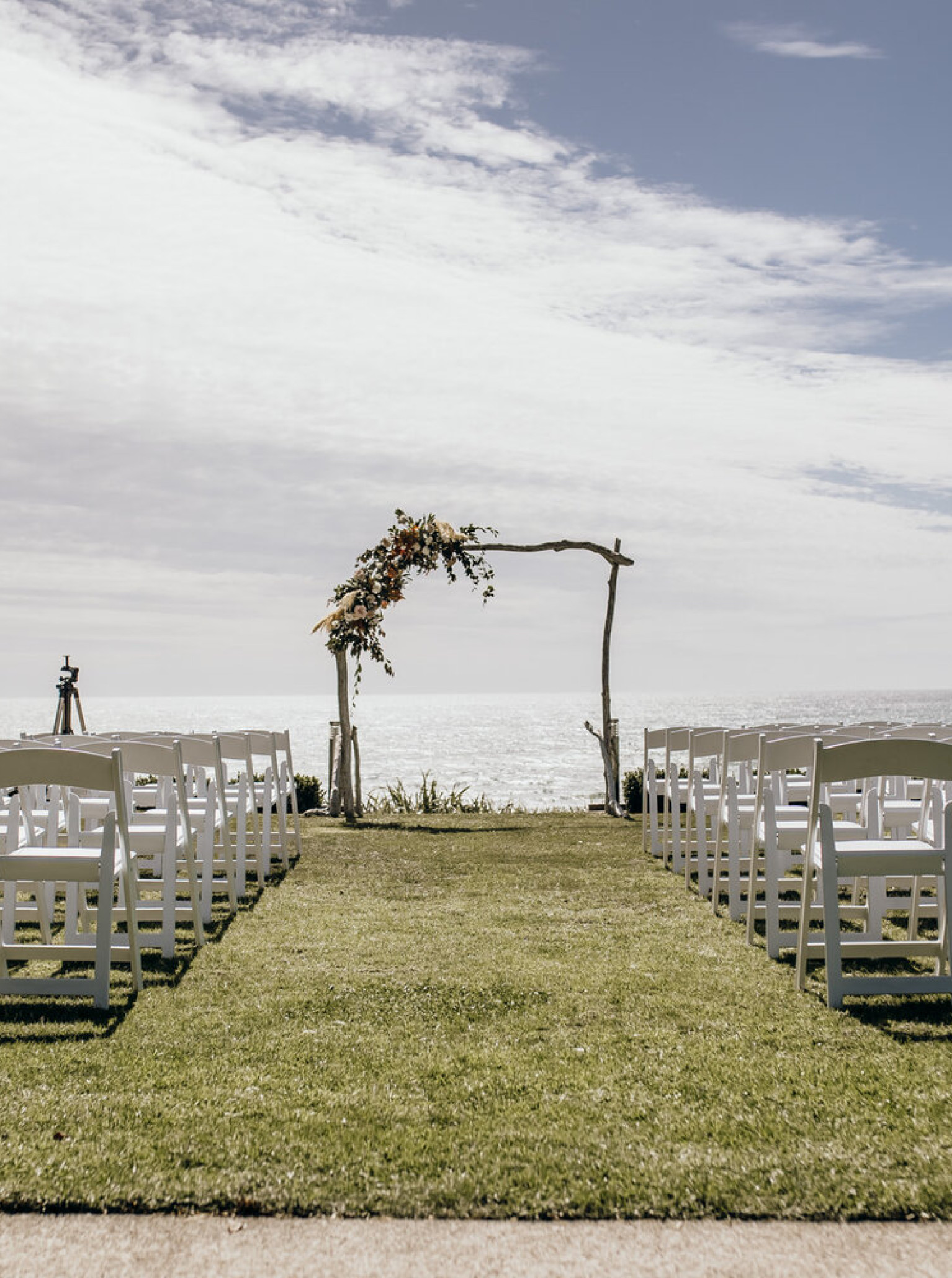 An outdoor wedding ceremony overlooking the ocean at the luxury coastal retreat, The Bungalow Coastal Retreat in New Plymouth.