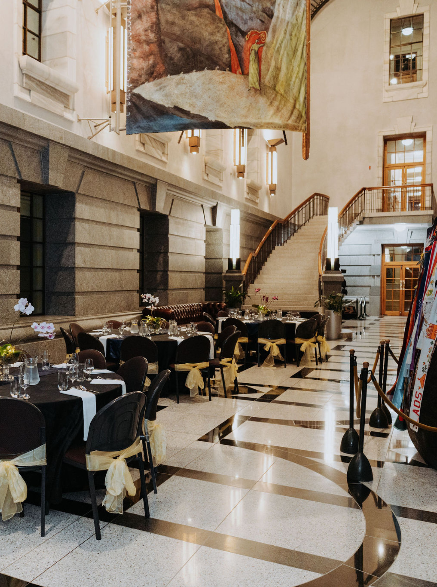 A formal dining setup within the grand, historic Gothic Revival architecture of Huihui - Parliament Events and Functions in Wellington.