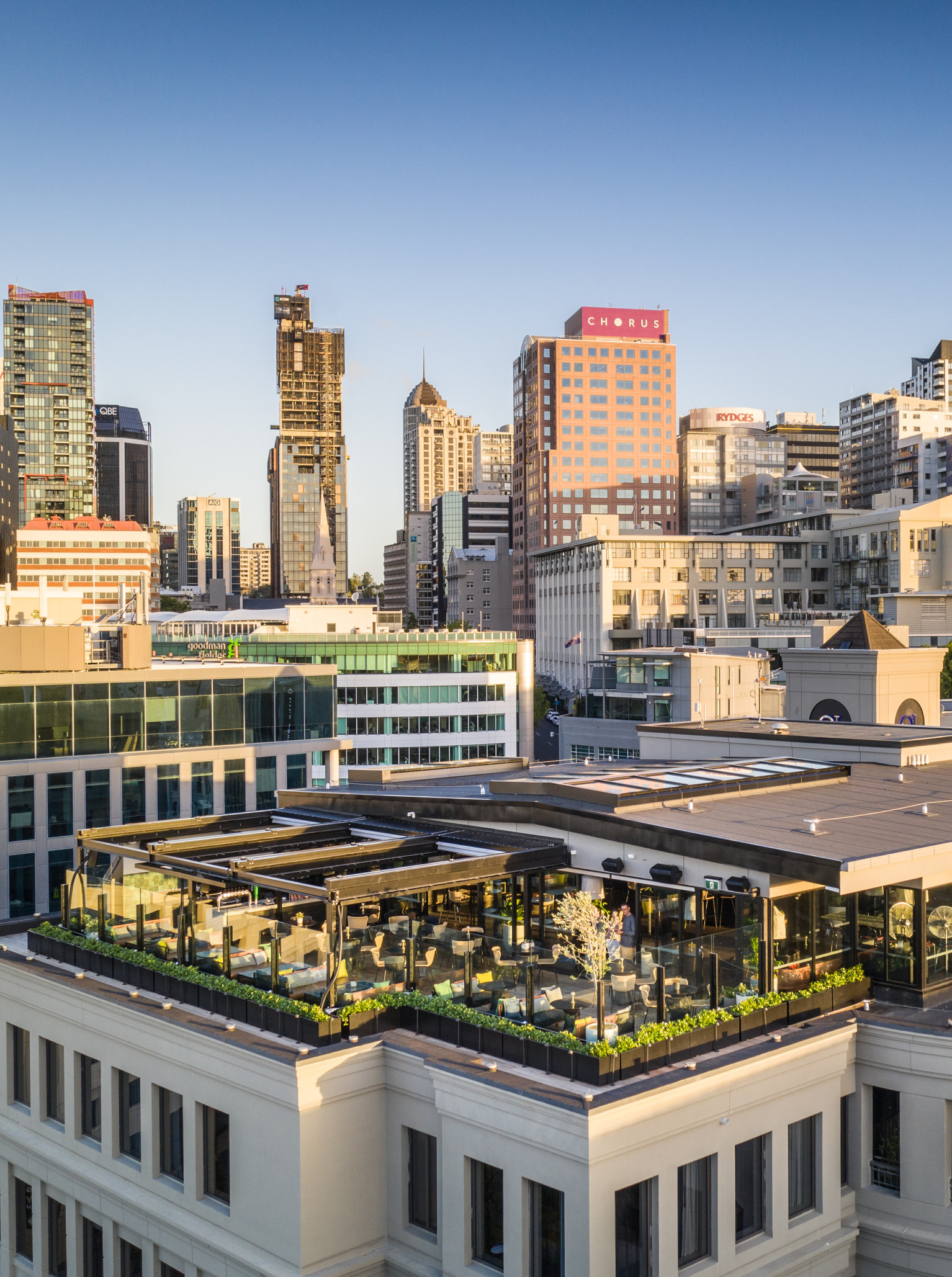 QT Auckland's elegant rooftop bar offers sophisticated indoor-outdoor dining with expansive city views.