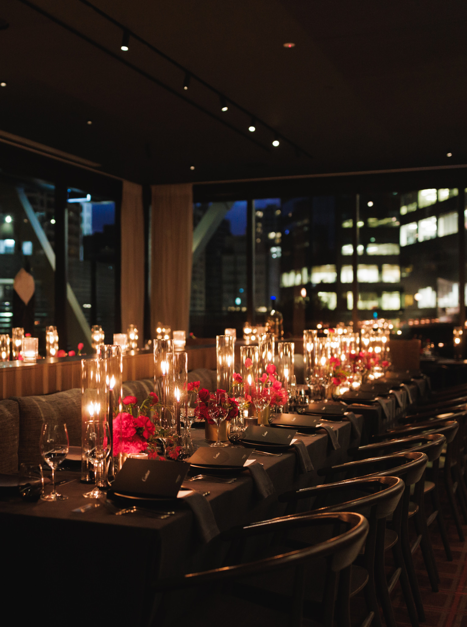 An intimate, candlelit private dining room at Onslow, Auckland's sophisticated modern restaurant, features a dark oak interior.