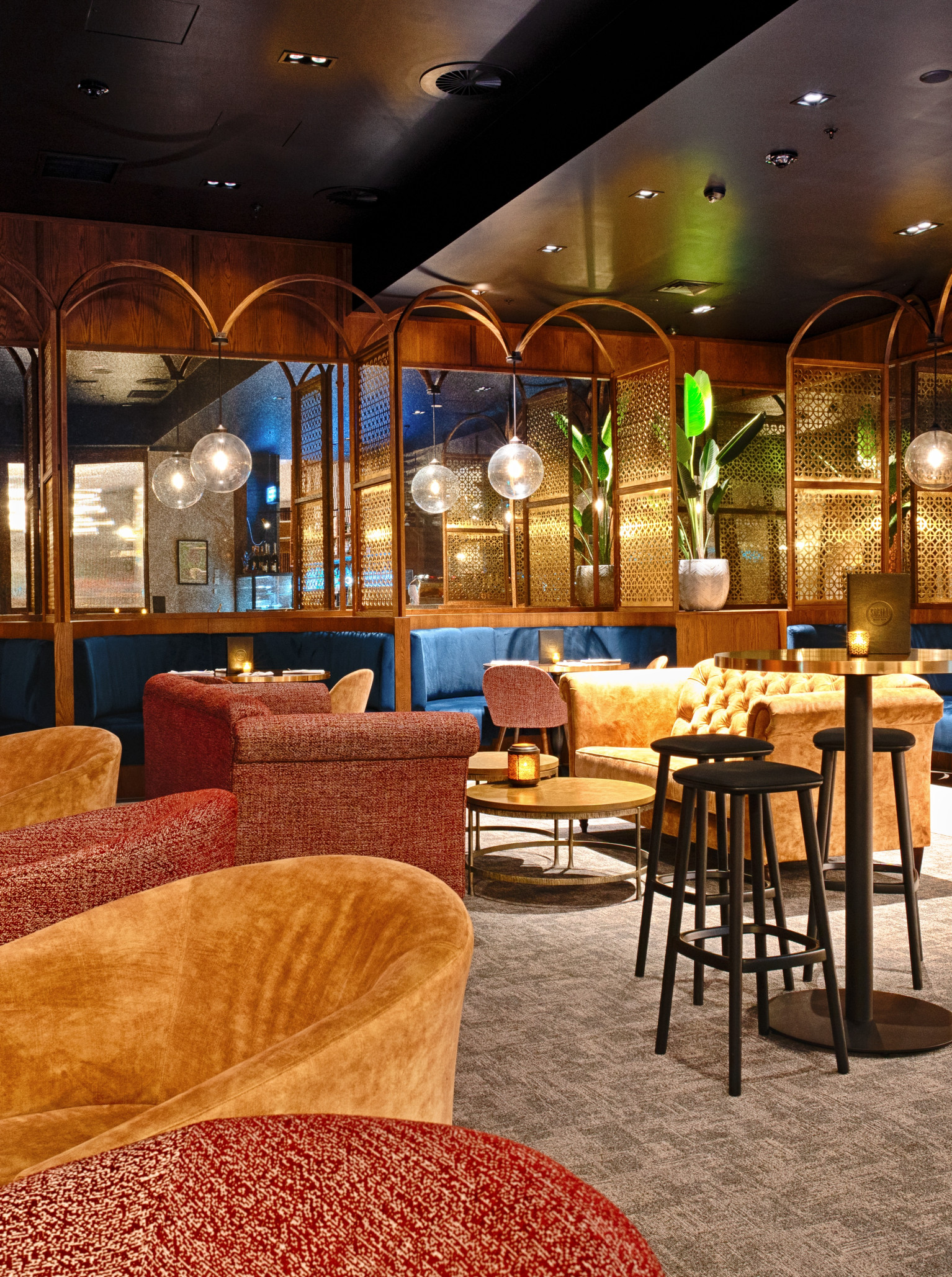 1851 Social Bar in Christchurch showcases a Gatsbyesque lounge with plush velvet seating, ornate gold partitions, and dimmed lighting.