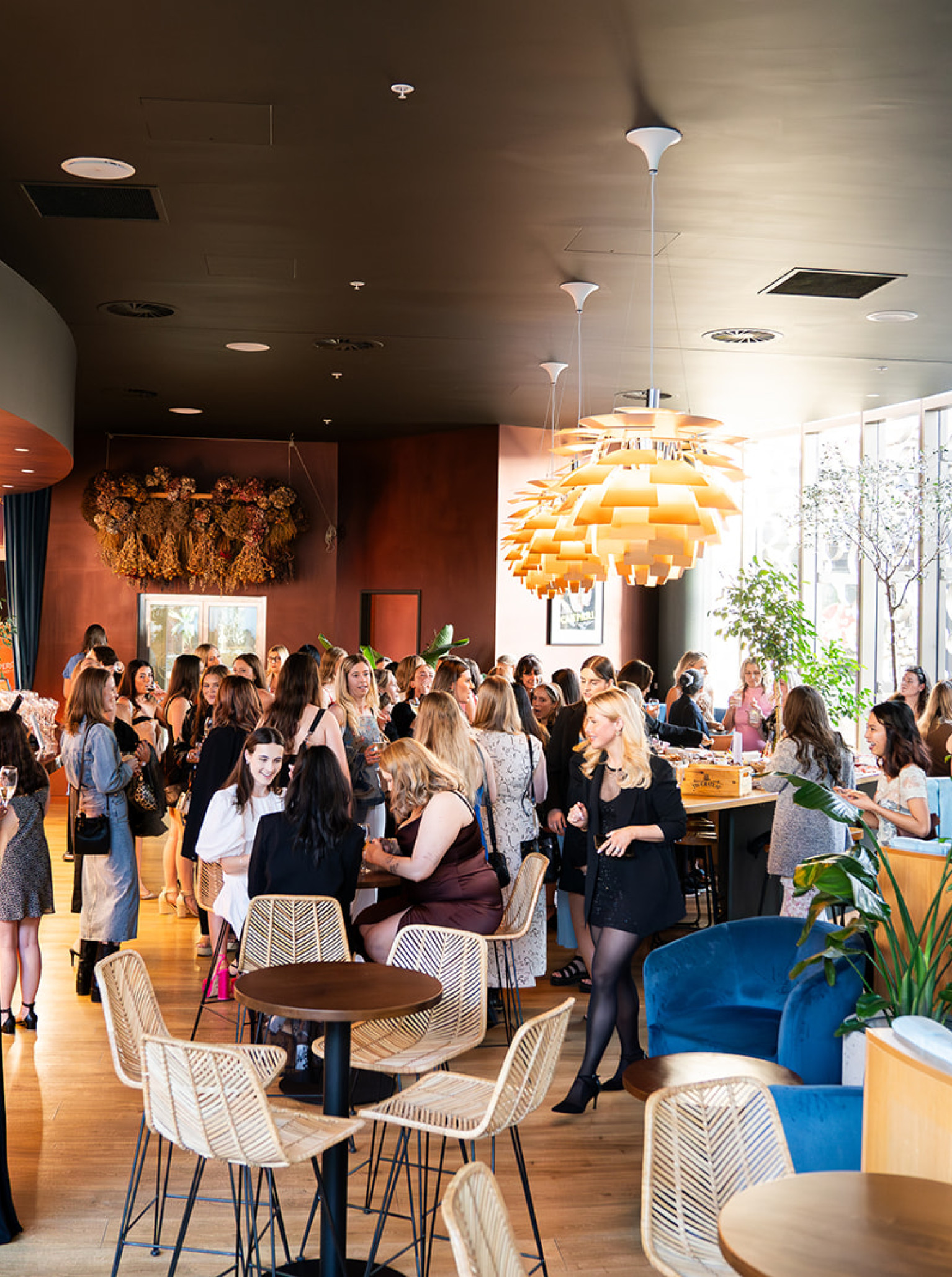 A vibrant event fills Bar Franco's modern Italian bar in Christchurch, with guests mingling amidst stylish decor.