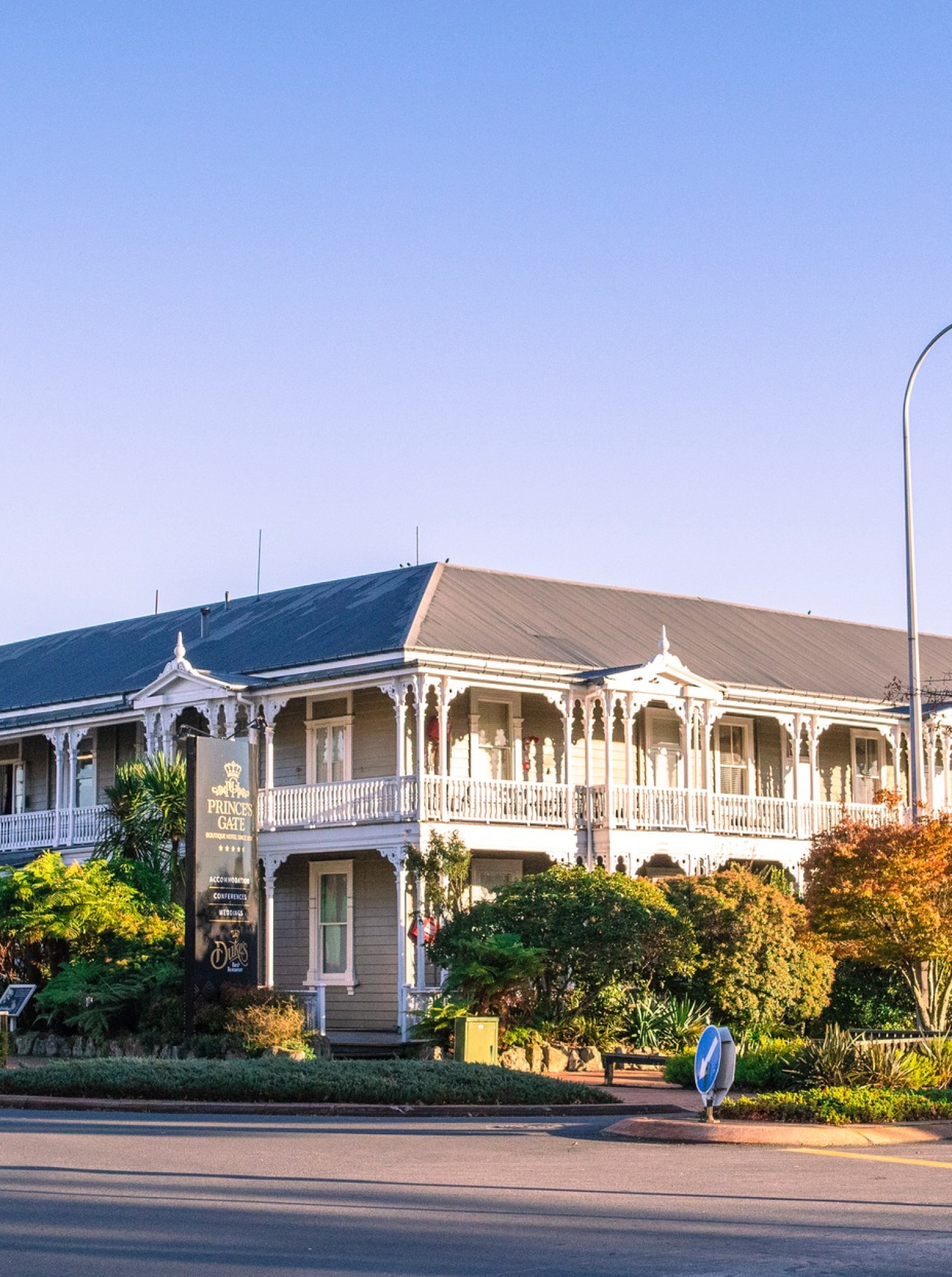 The Prince's Gate Hotel in Rotorua is a historic Edwardian building showcasing charming ornate balconies on its exterior.