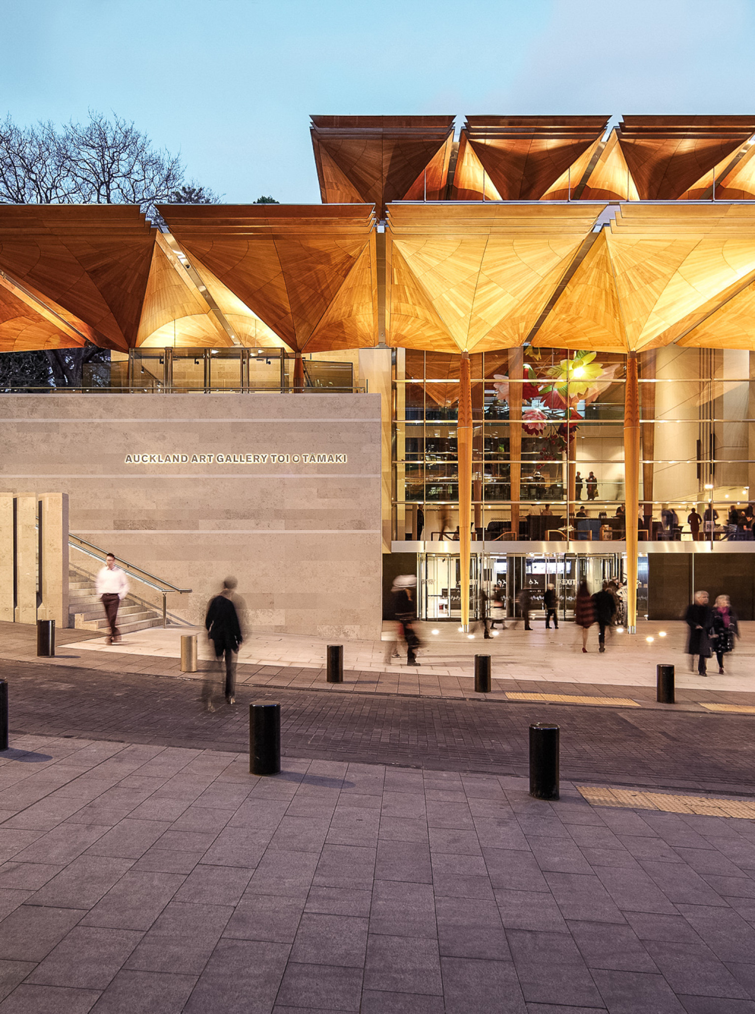 The contemporary entrance of the Auckland Art Gallery Toi o Tāmaki features distinctive timber canopies and glass.
