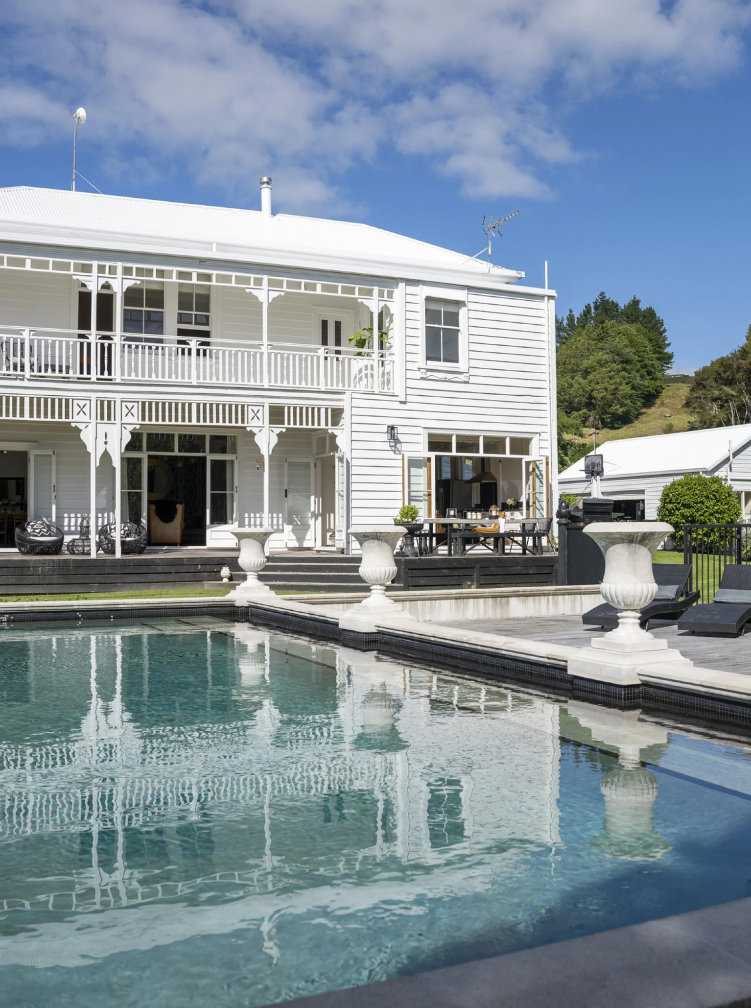 Outdoor pool and deck at La Maison, a grand historic villa in Clevedon, Auckland.