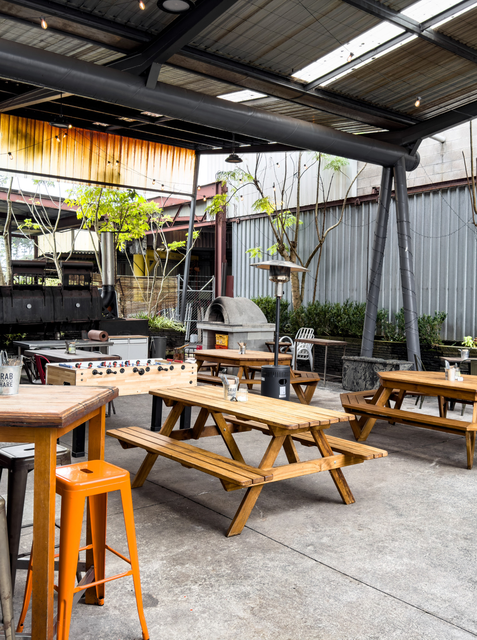 What-A-BBQ! in Auckland offers an industrial-chic outdoor dining area, reflecting its American BBQ smokehouse style.