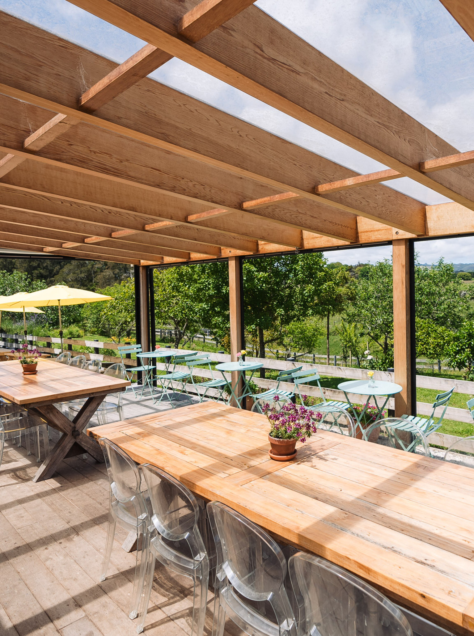The Farm House Cafe in Auckland features a rustic-chic outdoor dining patio with wooden pergolas and views of the Clevedon countryside.
