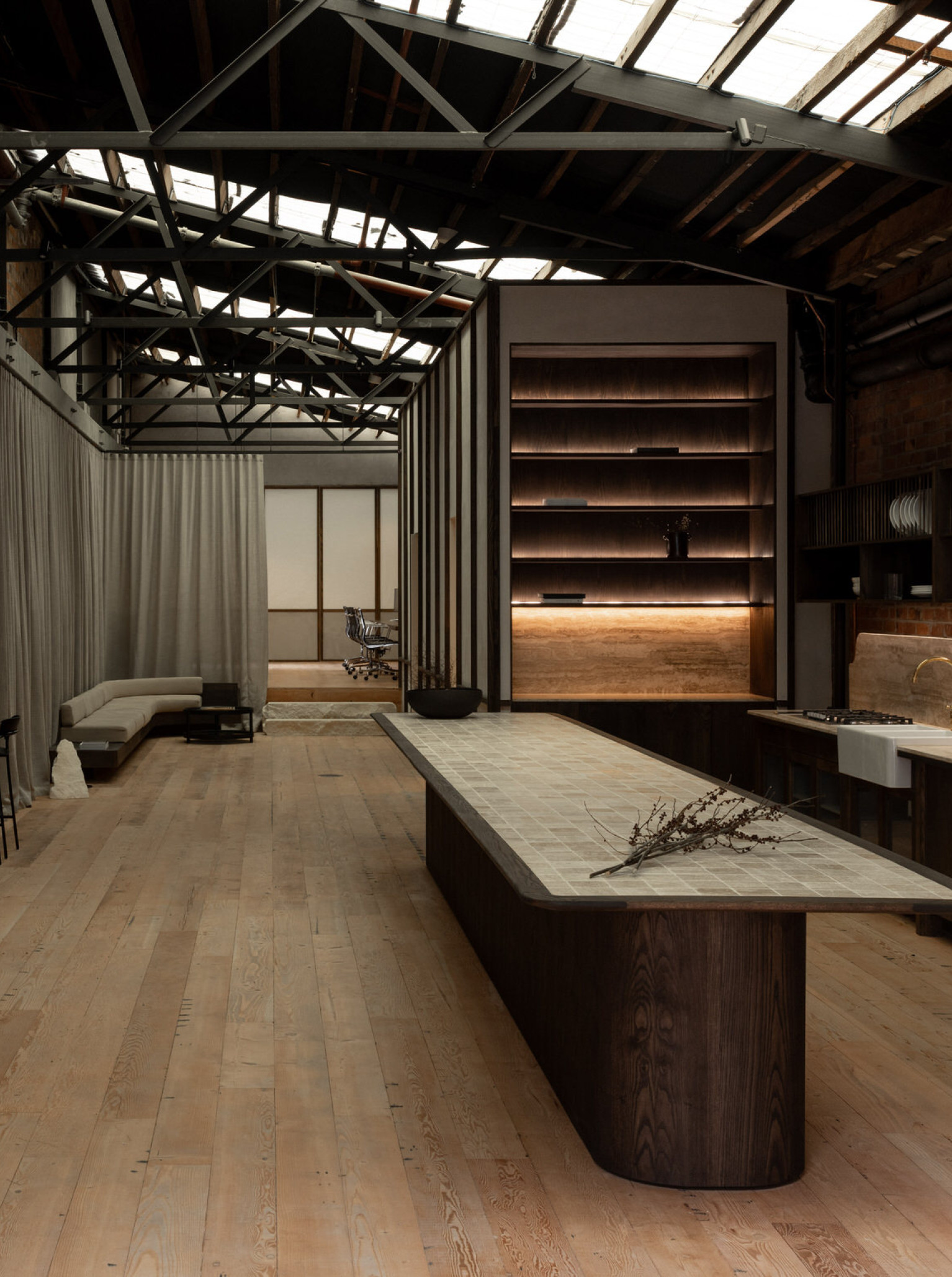 The modern industrial-chic event space at Casa Bella, Auckland, features exposed brick, timber floors, and a stylish central bar.