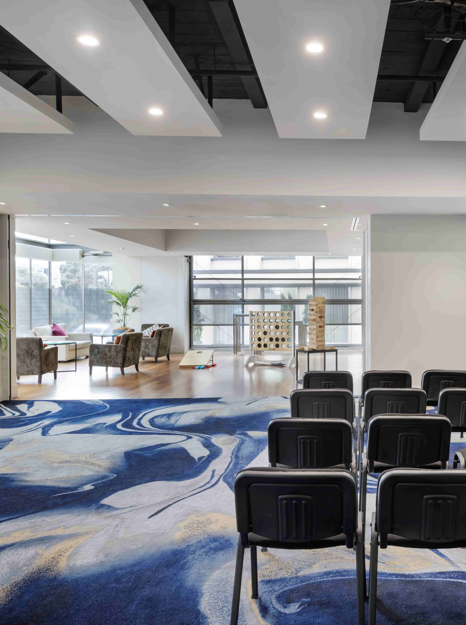 A contemporary meeting room and 'Meet & Play' breakout area with giant games at Pullman Auckland Hotel & Apartments.