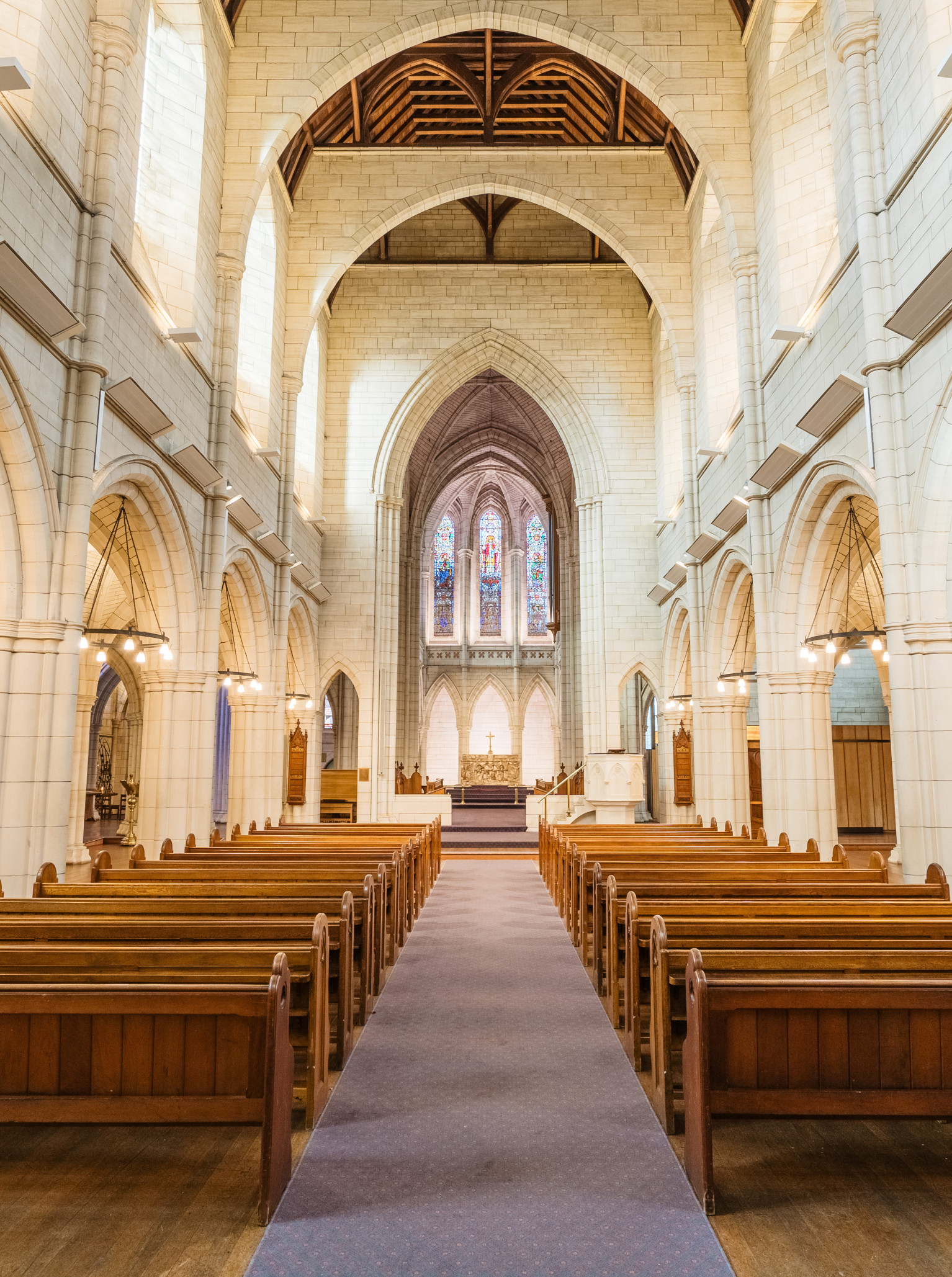 The majestic neo-Gothic stone interior of St Matthew-in-the-City, Auckland, with its elegant pews and vaulted arches.