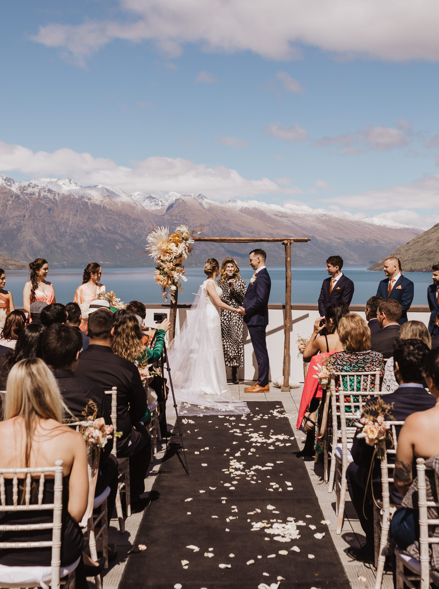 An outdoor ceremony at Rendezvous Heritage Hotel Queenstown, a modern alpine lodge with stunning lake and mountain views.