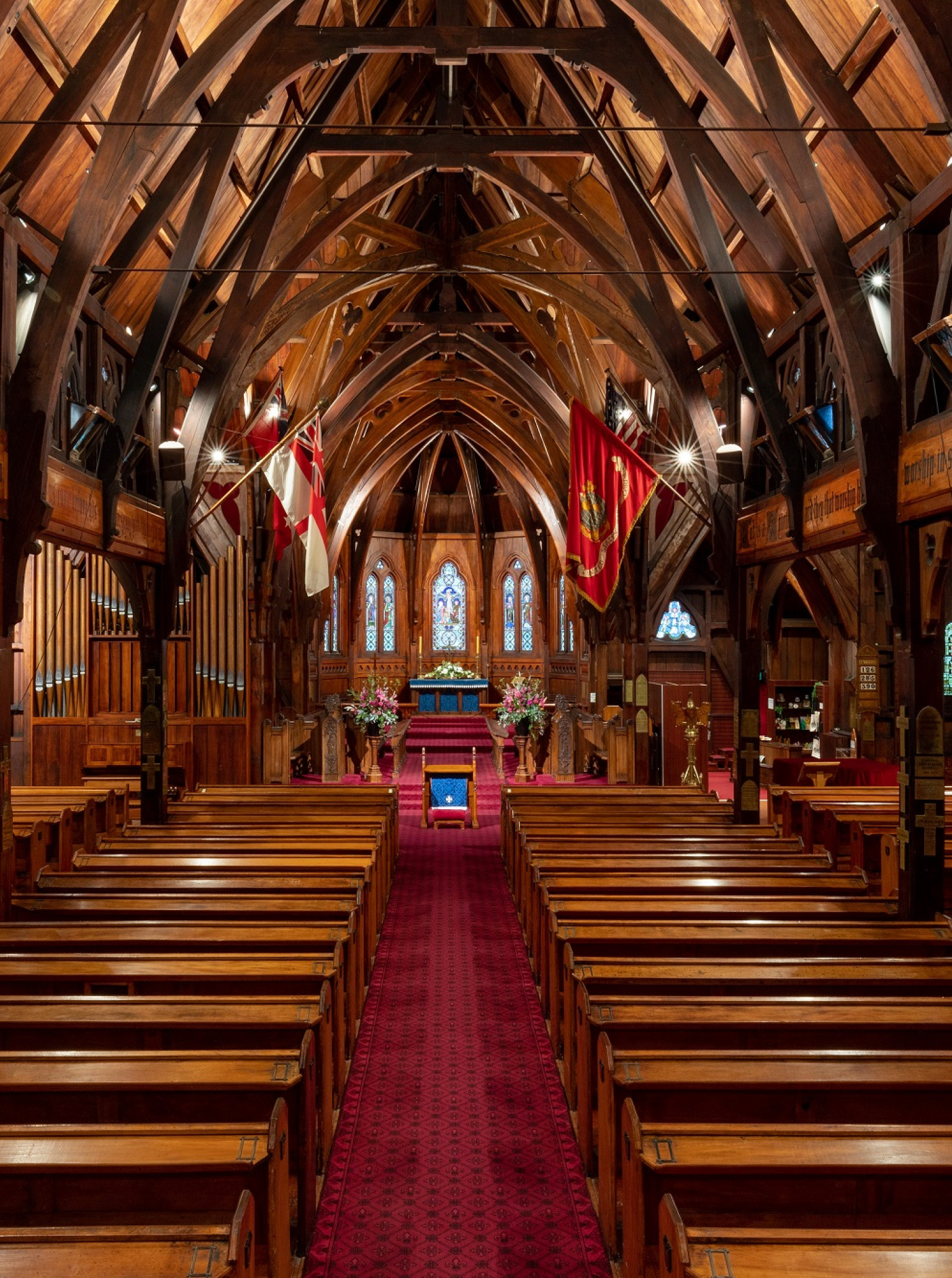 The striking timber Gothic Revival church interior of Old St Paul's, Wellington, with its central aisle and grand wooden beams.