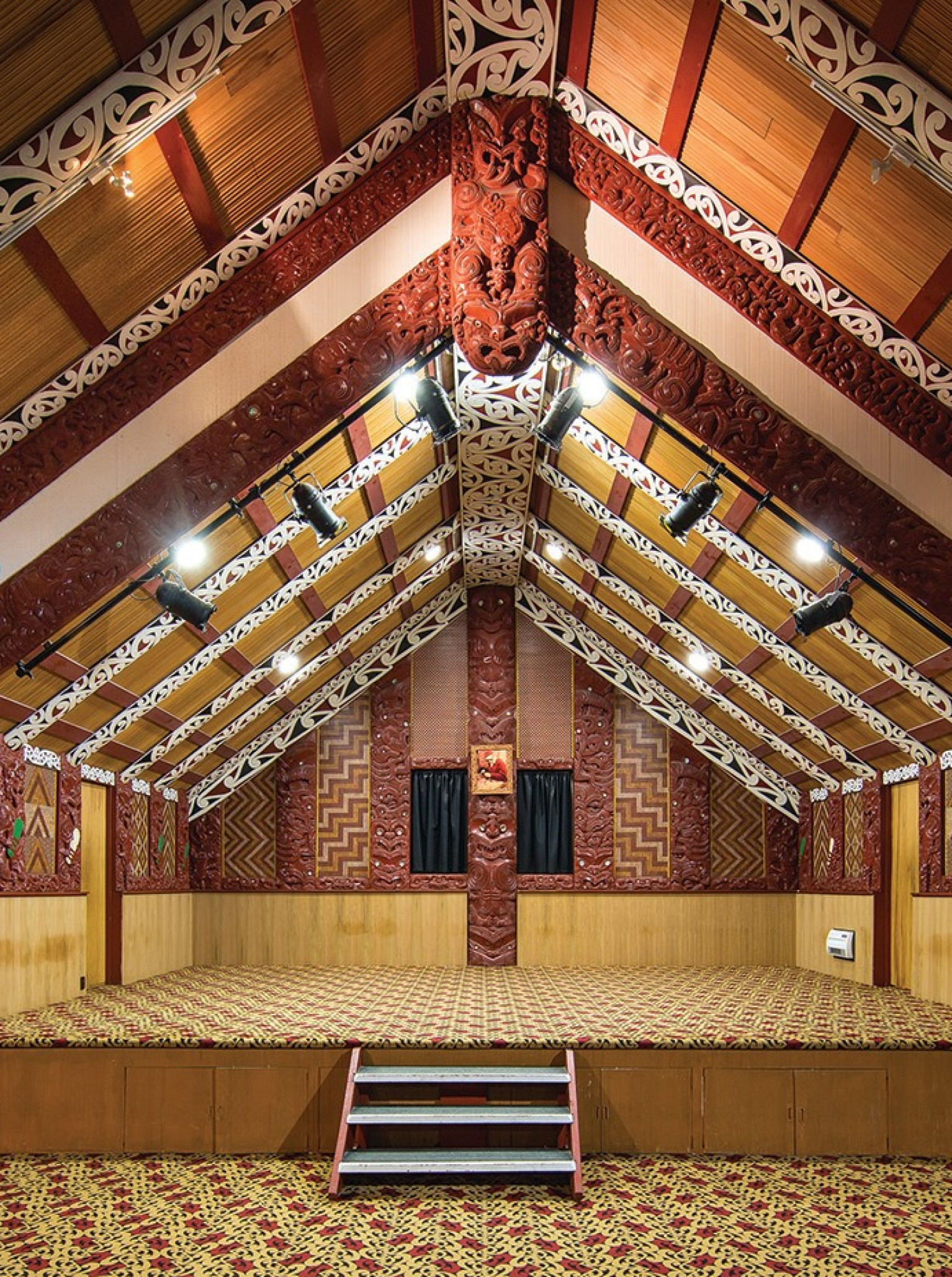 Te Puia, Rotorua, offers a cultural performance space within its richly carved traditional Māori meeting house.