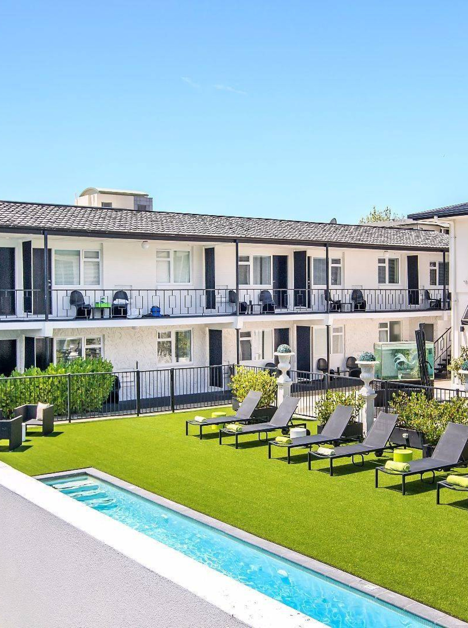 The modern boutique Regent of Rotorua in Rotorua features an inviting outdoor pool courtyard with sun loungers.