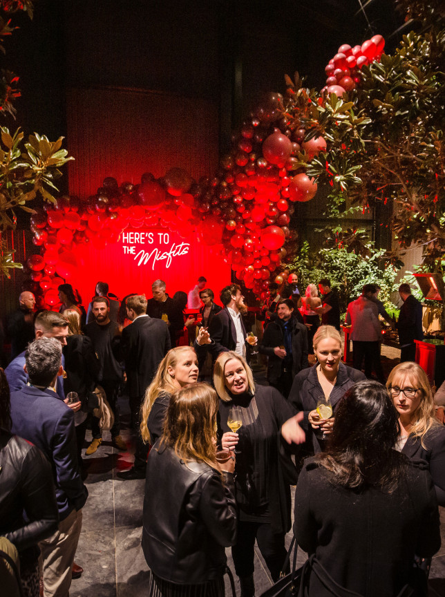 Smoke - Event Photo + Video captures a vibrant Auckland social event with contemporary red lighting and botanical accents.
