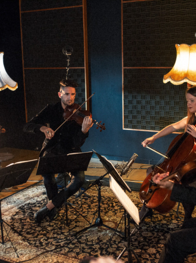 Auckland's Black Quartet performs their contemporary string music in a sophisticated studio adorned with classic lamps.