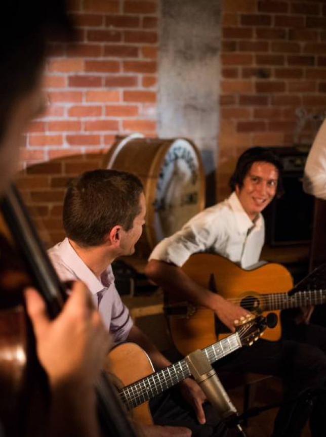 Twistin' the Swing performs lively gypsy jazz in an intimate, brick-walled venue in Auckland.