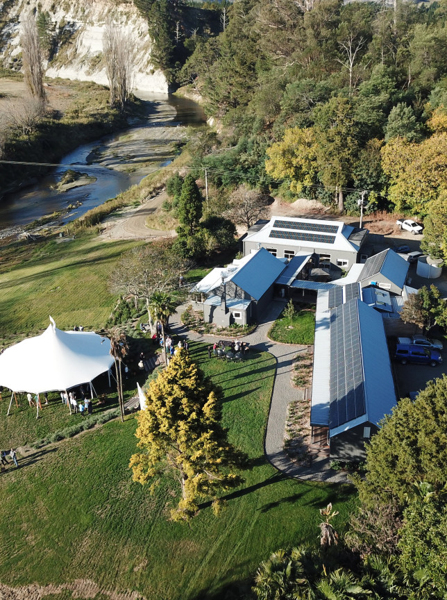 An outdoor event with a white marquee is underway at Omatua, a rural riverside venue in Hawke's Bay.