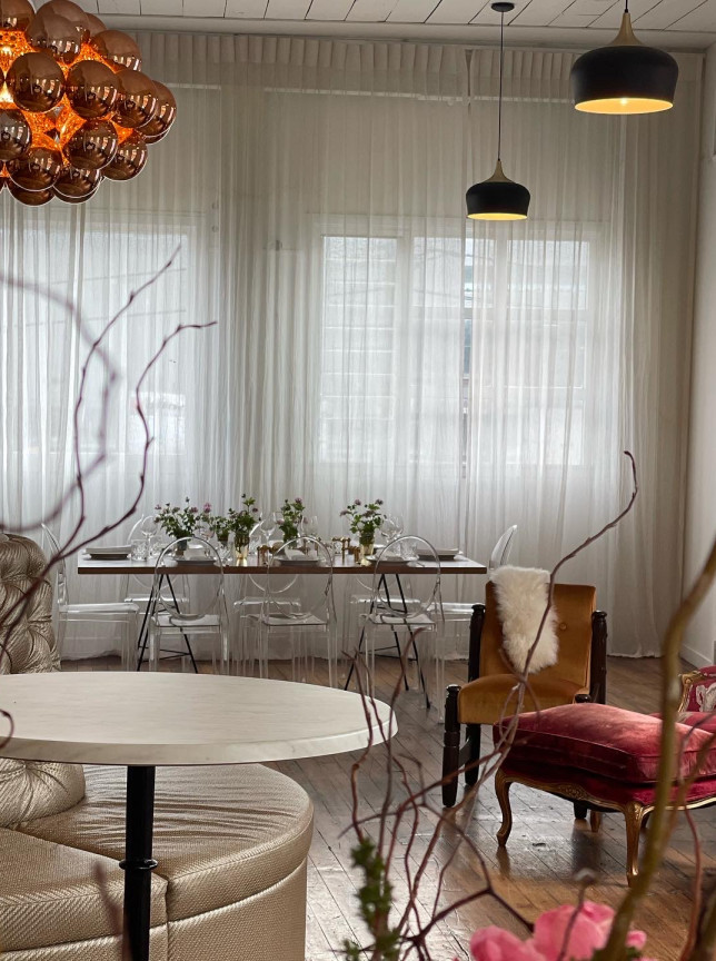 A chic private dining space at The Canapé Room, Wellington, features elegant vintage furnishings and abundant natural light.