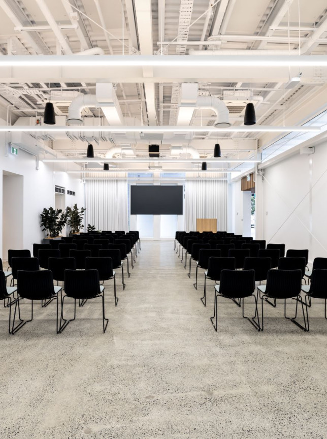 A contemporary, industrial-chic event space at The Annex, 10 Madden Street by Precinct Flex in Auckland, arranged theatre-style for presentations.