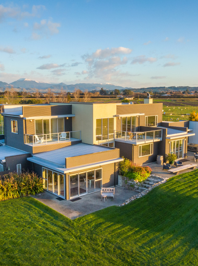 Appleby House in Nelson-Tasman features a luxurious, contemporary multi-level building with expansive windows, balconies, and sprawling lawns, ideal for events.