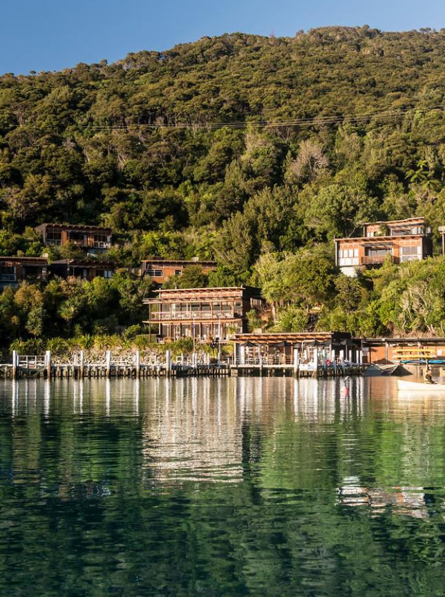Bay of Many Coves Resort's contemporary, wood-clad apartments are integrated into the lush Marlborough hillside above a scenic bay and pier.