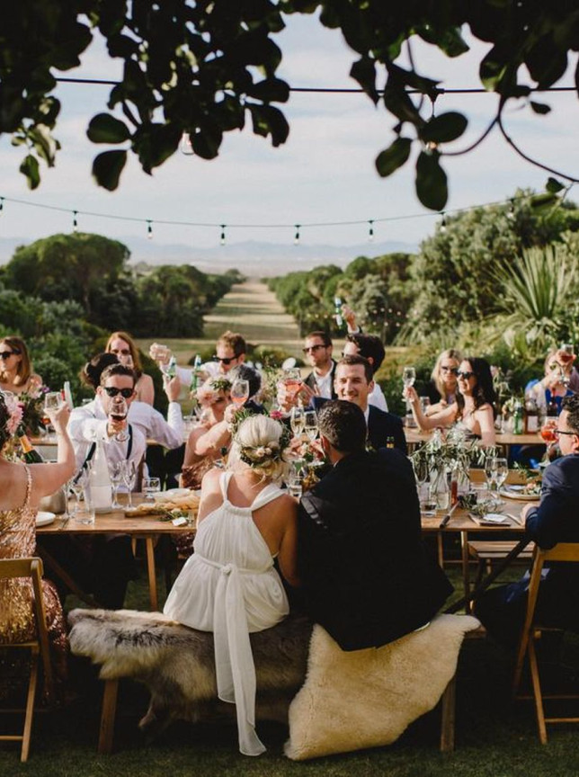 Guests toast at an outdoor reception in Paripuma's nationally significant native gardens in Marlborough.