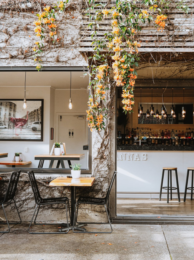 An inviting garden bar area with lush vines and outdoor seating at Rosanna's in Auckland.