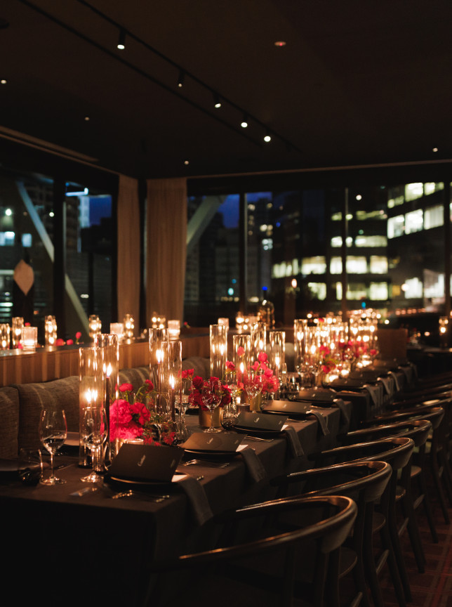 An intimate, candlelit private dining room at Onslow, Auckland's sophisticated modern restaurant, features a dark oak interior.