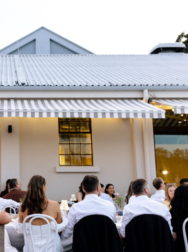 Guests enjoy outdoor dining at Fabric Cafe Bistro, a European-inspired venue in a historic industrial building in Auckland.