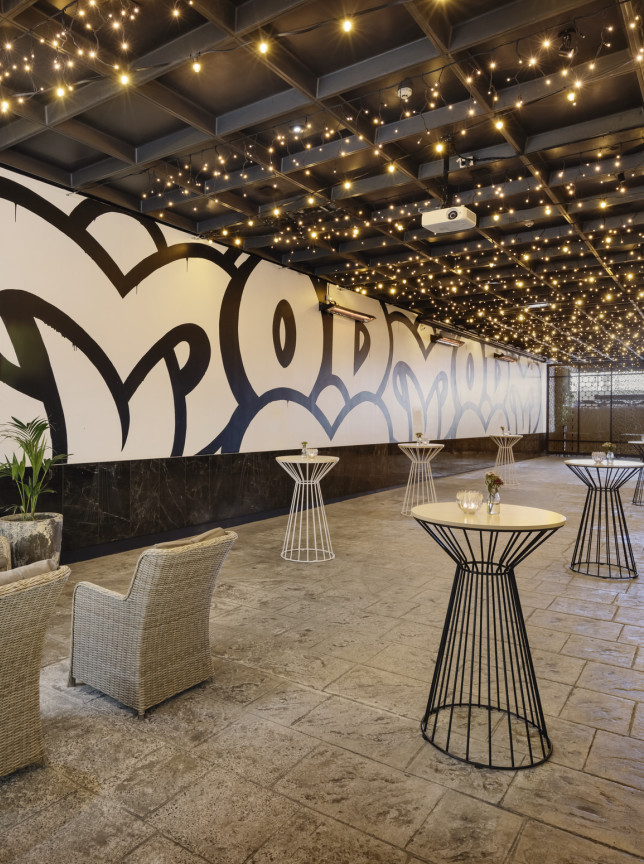 Custom Lane, an urban-chic lounge and event space at Mövenpick Hotel Auckland, features a living wall and eclectic street art.