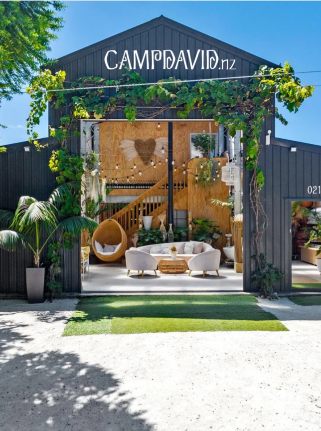 Balinese-inspired gardens and a modern barn host a chic indoor lounge area at Camp David Function Venue, Auckland.