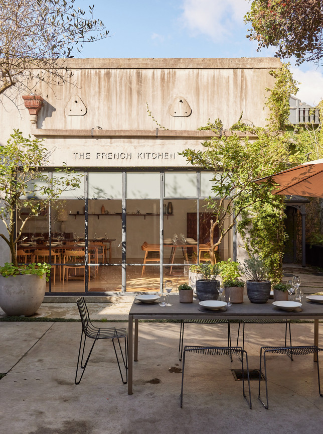 An outdoor dining area in The French Cafe's romantic European-inspired courtyard in Auckland.