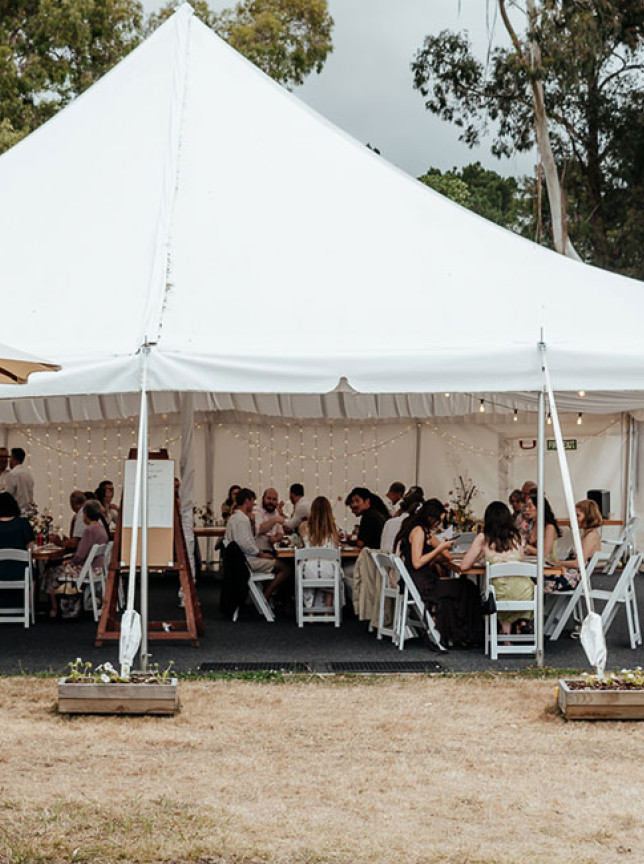 An outdoor marquee reception for guests at Tironui Farm, a rustic Wellington wedding venue.
