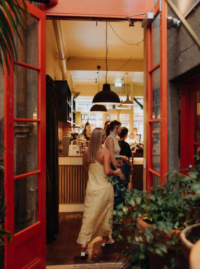 A bright red entrance welcomes patrons into the Cuba Street Tavern in Wellington, a lively and funky community hub.