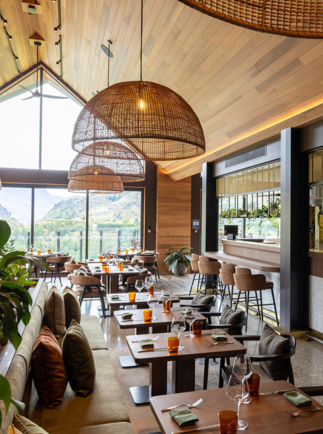 Coronet Ridge Resort Queenstown's alpine-luxury restaurant showcases natural timber, an open kitchen, and stunning mountain views.