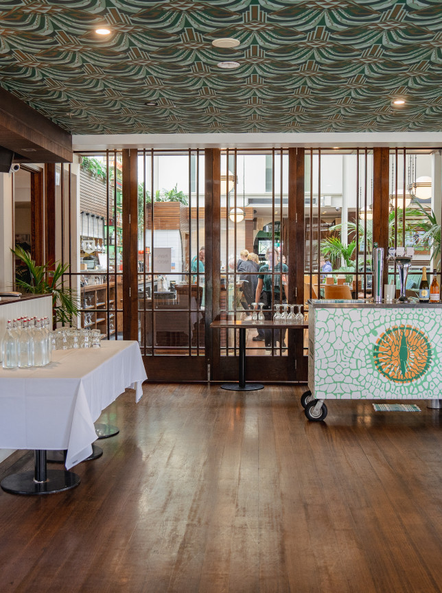 An elegant Art Deco event space at St Johns Bar & Eatery, Wellington, showcasing a mobile bar and distinctive patterned ceiling.