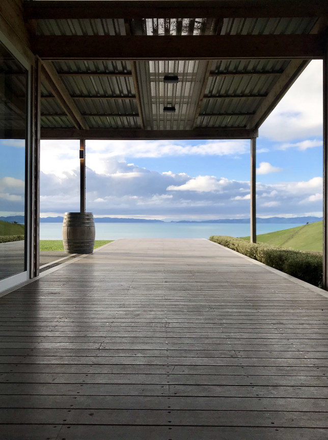 Kauri Bay in Auckland features a modern-rustic covered deck offering panoramic views of the Hauraki Gulf.