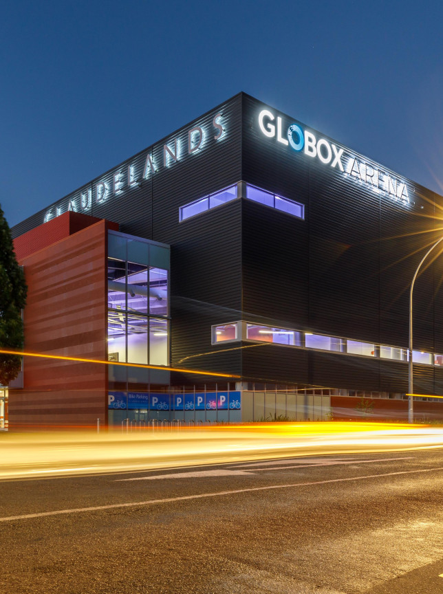The contemporary Claudelands Events Centre and Globox Arena in Hamilton, featuring Māori-inspired design, glows at dusk with light trails.