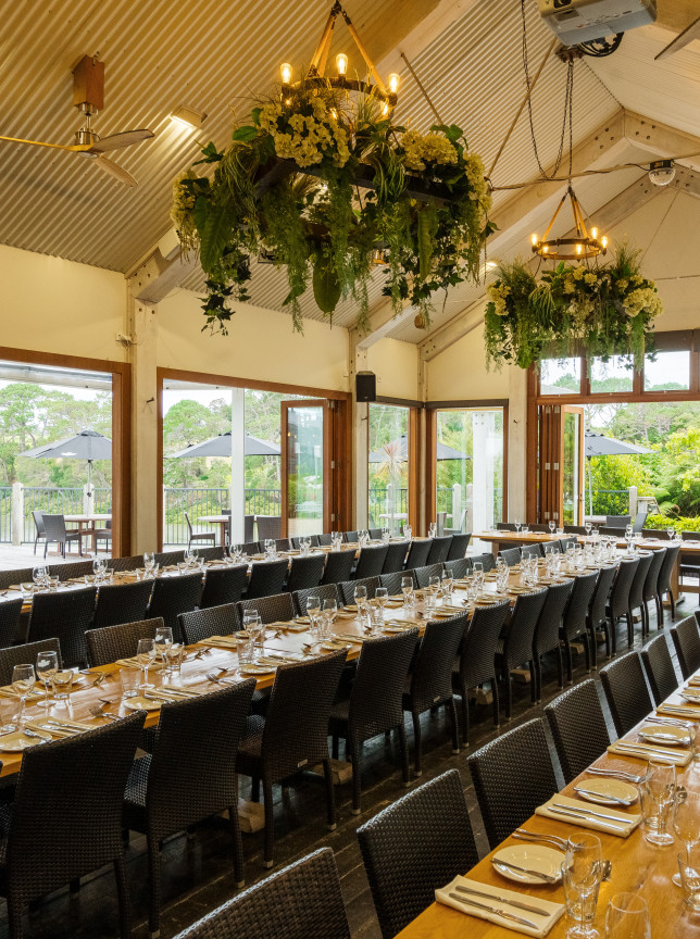 The Boat House Auckland's rustic boathouse-style dining room offers elegant banquet seating and outdoor views.