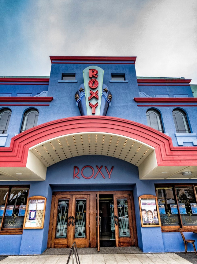 The Roxy, Wellington's vibrant Art Deco cinema, showcases a striking blue facade with red accents and a classic marquee.