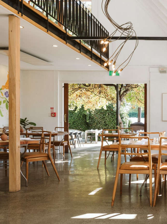 St George's Restaurant in Hawke's Bay offers an airy, modern European-inspired dining room with wooden furniture and outdoor views.