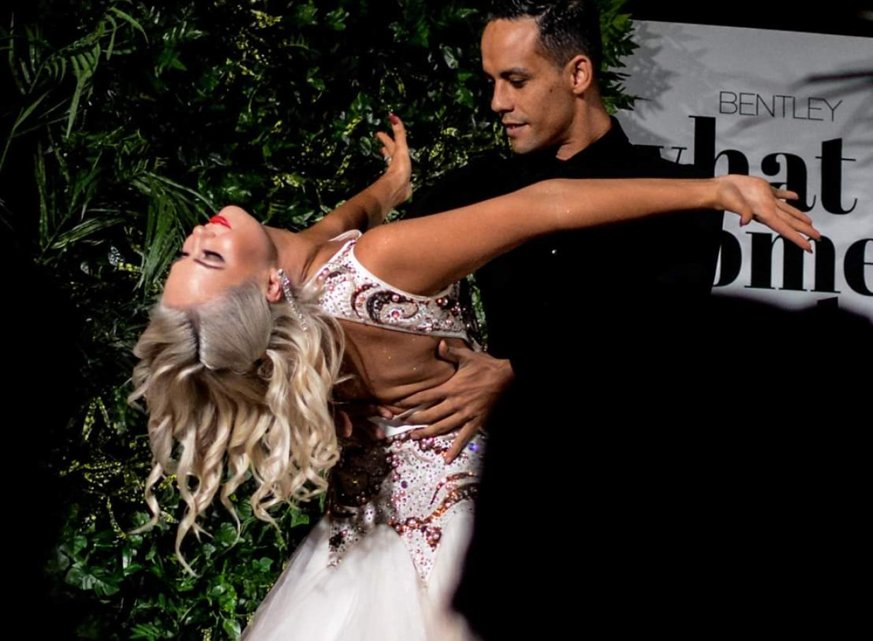 Finesse Entertainment Auckland showcases a dynamic performance by two professional dancers in elegant ballroom attire.