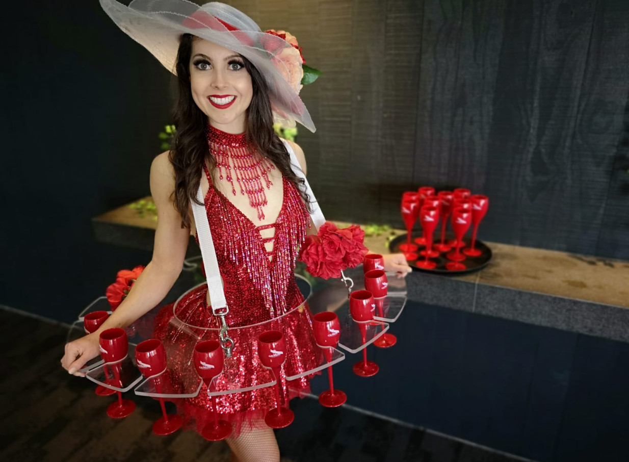 A Finesse Entertainment performer in Auckland providing bespoke meet & greet entertainment with a champagne skirt.