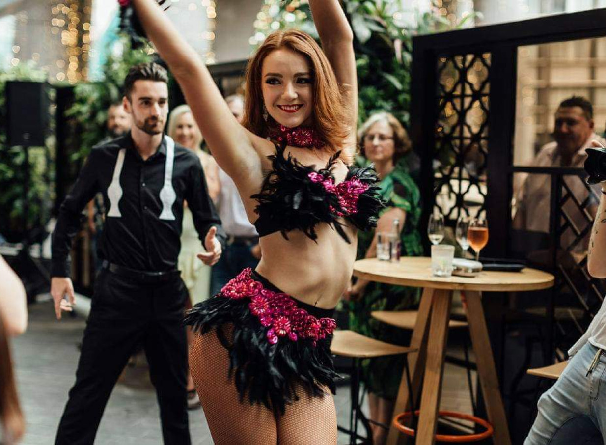 An energetic dance performance by Finesse Entertainment at a contemporary Auckland event venue.
