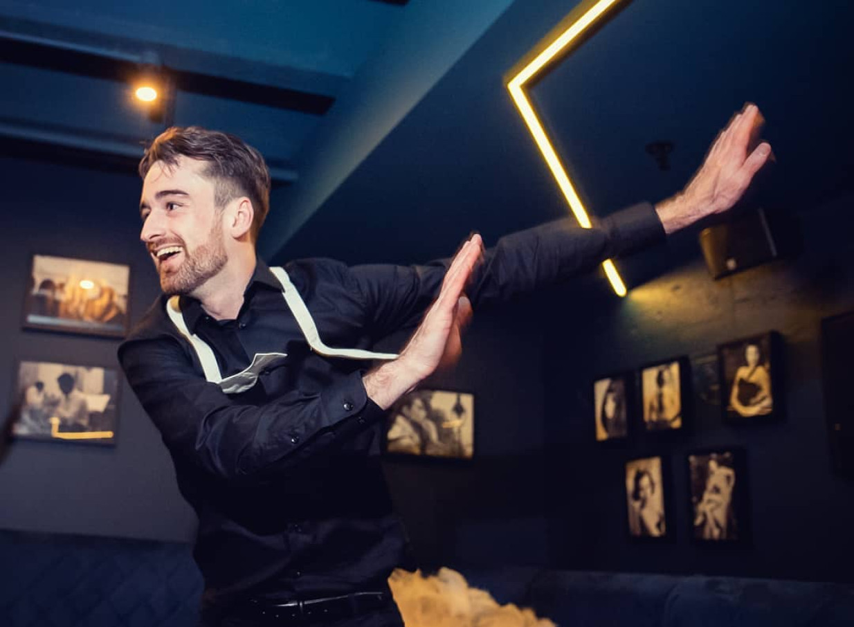 Finesse Entertainment delivers dynamic dance in a lively Auckland event space with atmospheric neon lights.